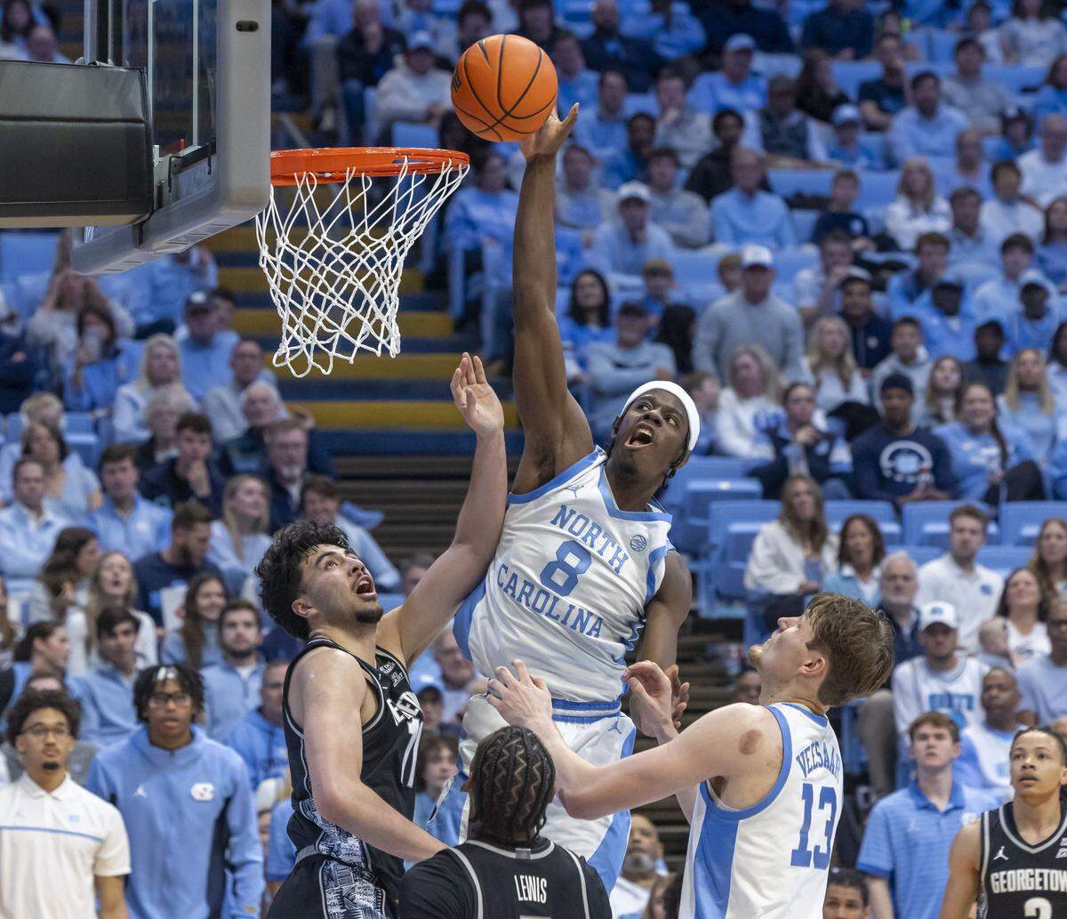 North Carolina forward Caleb Wilson (8) puts up a shot against Georgetown center Julius Halaifonua (11) in the second half on Sunday, December 7, 2025 at the Smith Center in Chapel Hill, N.C.  Wilson lead the Tar Heels with 20 points in their 81-61 victory.