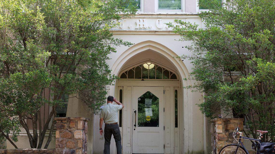 A person stands near an entrance to the Campus Y building on Friday, May 3, 2024, at UNC-Chapel Hill. According to the university, the building was closed on April 30 for safety reasons.