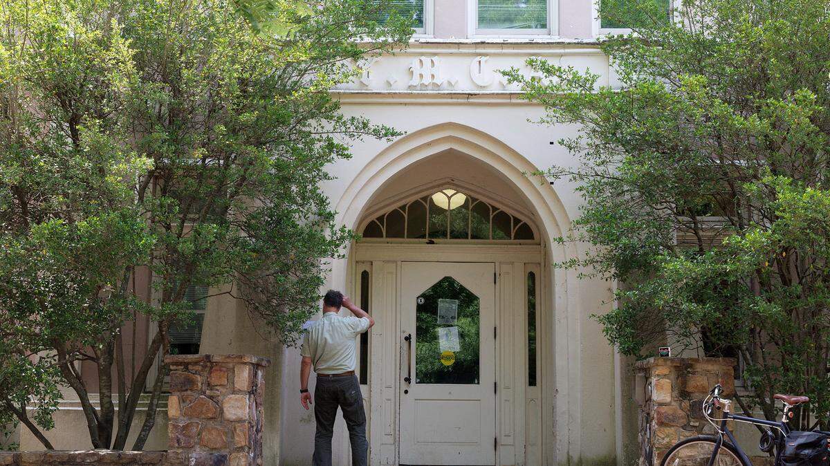 A person stands near an entrance to the Campus Y building on Friday, May 3, 2024, at UNC-Chapel Hill.