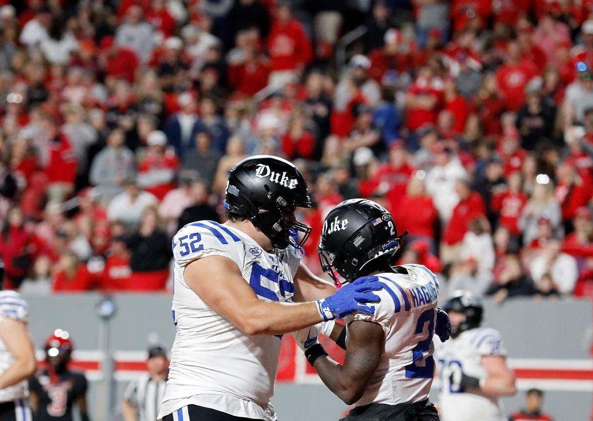 Duke’s Sahmir Hagans celebrates with teammate Micah Sahakian after scoring a touchdown during the second half of the Blue Devils’ 29-19 win over N.C. State on Saturday, Nov. 9, 2024, at Carter-Finley Stadium in Raleigh, N.C.