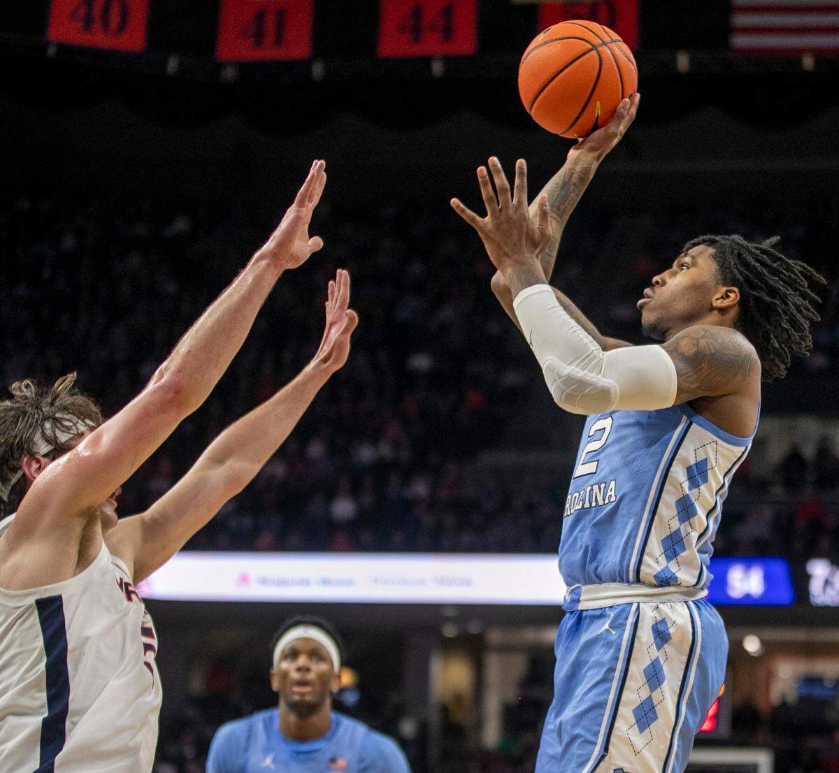 North Carolina’s Caleb Love (2) drives to the basket against Virginia’s Ben Vander Plas (5) in the second half on Tuesday, January 10, 2023 at John Paul Jones Arena in Charlottesville, Va. Love scored 13 points.