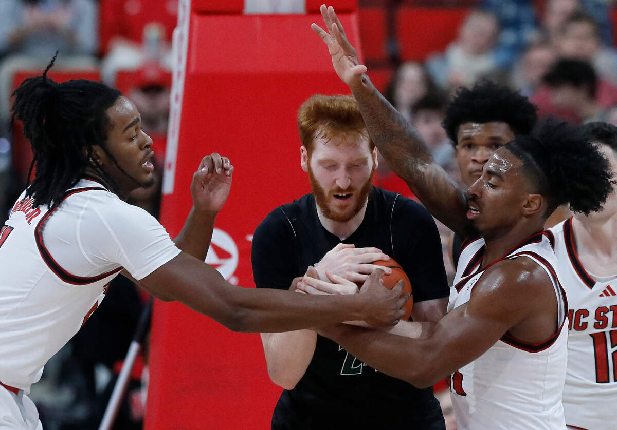 N.C. State’s Dennis Parker Jr. and Marcus Hill pressure William & Mary’s Keller Boothby during the first half of the Wolfpack’s 84-61 win at Lenovo Center on Friday, Nov. 22, 2024, in Raleigh, N.C.