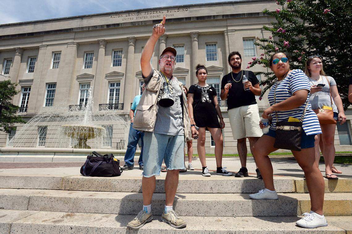 Mike Hartle, who calls himself Spiel Stevenberg. gestures to the Cape Fear River while on the steps of the Alton Lennon Federal Building in Wilmington, N.C. Tuesday, July 26, 2016. He was leading a group of film buffs on the Hollywood Location Walk pointing out various areas where movies and television shows have been filmed in the riverside town.