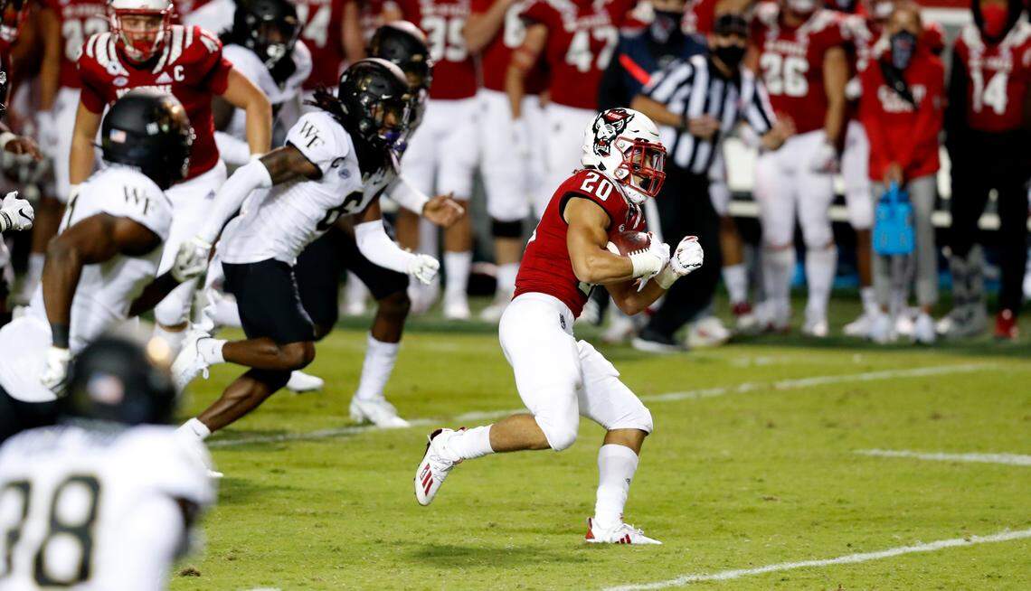 N.C. State running back Jordan Houston (20) gains yards during the second half of N.C. State’s 45-42 victory over Wake Forest at Carter-Finley Stadium in Raleigh, N.C, Saturday, Sept. 19, 2020.