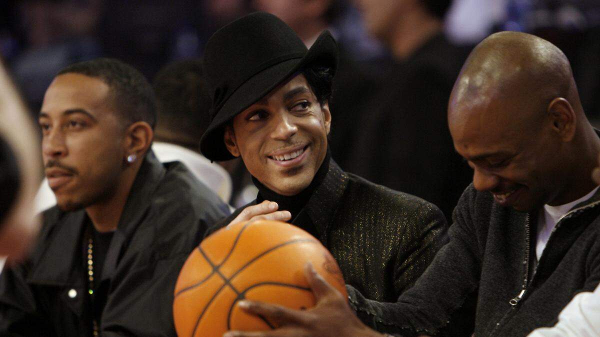 From left, entertainers Chris “Ludacris” Bridges, Prince and David Chapelle watch the NBA All-Star basketball game in Las Vegas on Sunday, Feb. 18, 2007. (AP Photo/Kevork Djansezian)