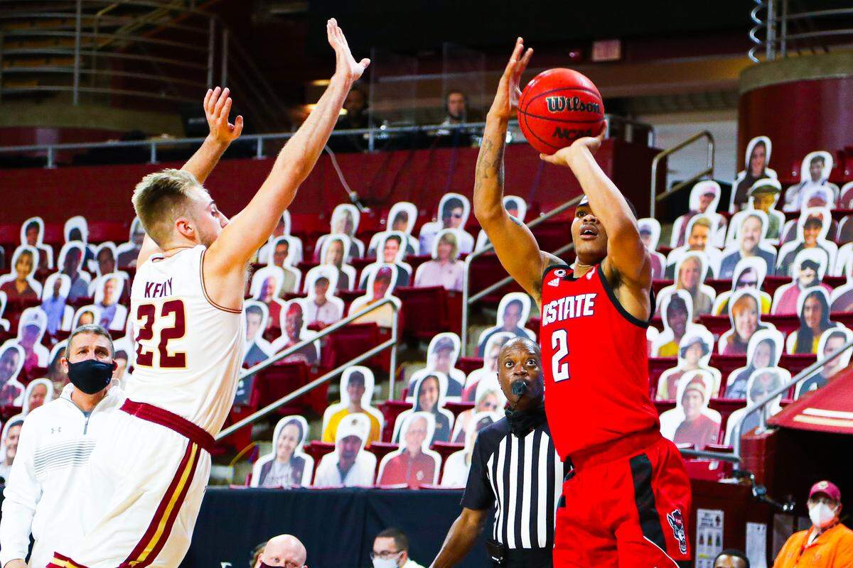 N.C. State guard Shakeel Moore shoots over Boston College defender Rich Kelly in first half action Saturday, Feb. 6, 2021.