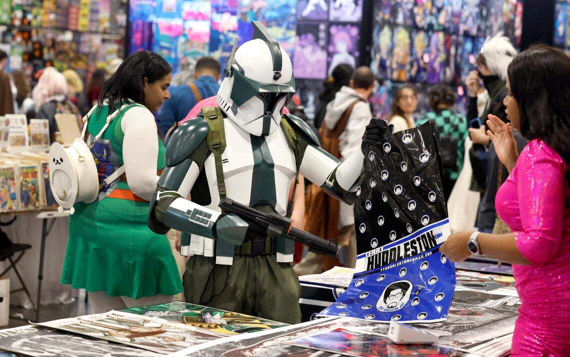 Chris Robinson of Durham, dressed as a Phase I Clone Trooper, goes shopping during GalaxyCon Raleigh at the Raleigh Convention Center Saturday, July 29, 2023.