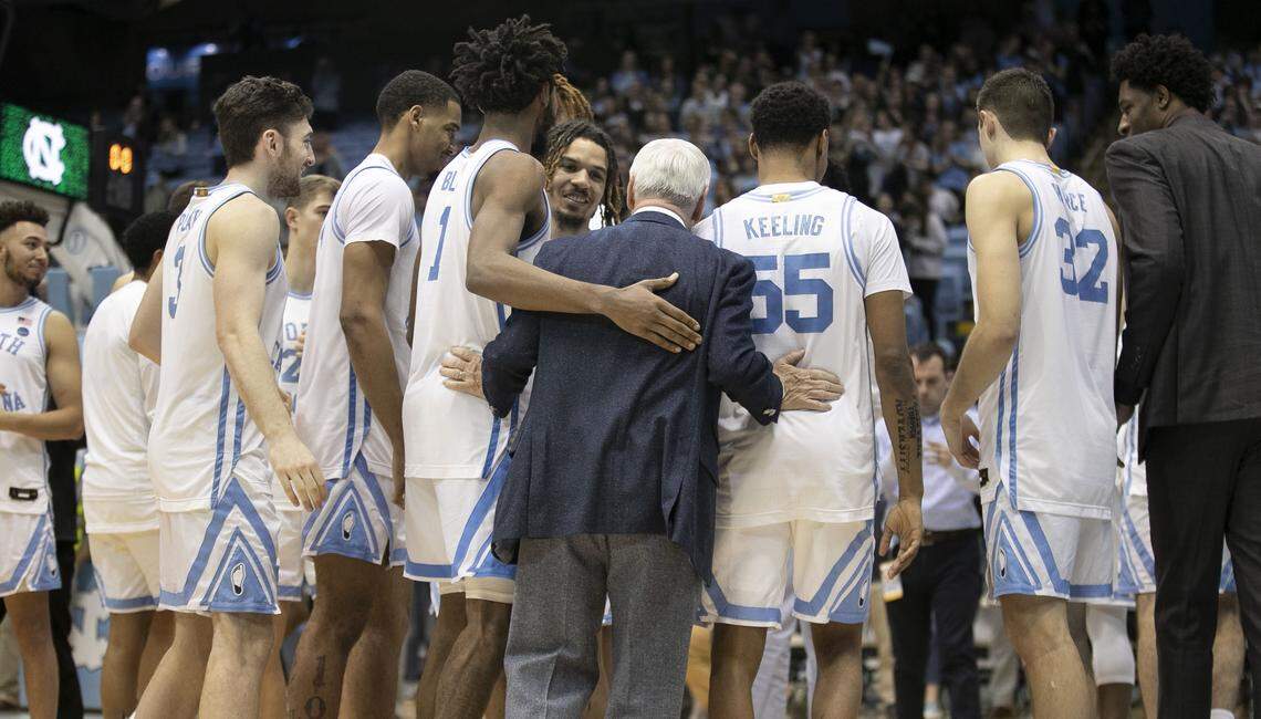North Carolina coach Roy Williams embraces his players as they leave the court following the recognition of senior team members following the win over Wake Forest on Tuesday, March 3, 2020 at the Smith Center in Chapel Hill, N.C.