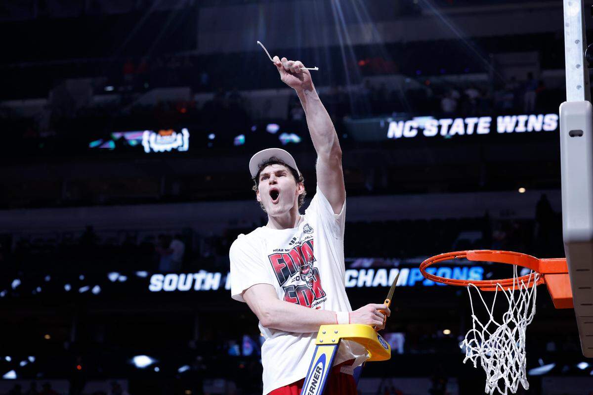 N.C. State’s Ben Middlebrooks (34) holds up a piece of th net after the Wolfpack’s 76-64 victory over Duke in their NCAA Tournament Elite Eight matchup at the American Airlines Center in Dallas, Texas, Sunday, March 31, 2024.