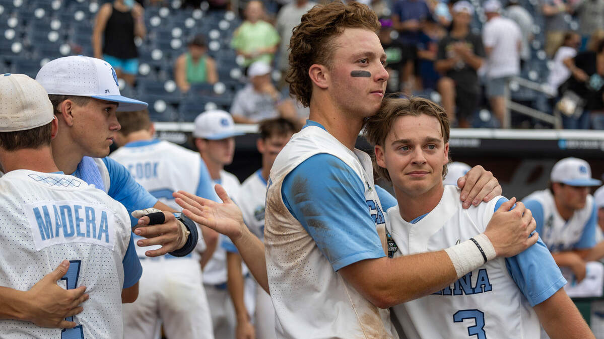 North Carolina outfielder Vance Honeycutt (7) embraces short stop Colby Wilkerson (3) following the Tar Heels’ season ending 9-5 loss to Florida State in game nine of the College World Series on Tuesday, June 18, 2024 at Charles Schwab Field in Omaha, Nebraska.