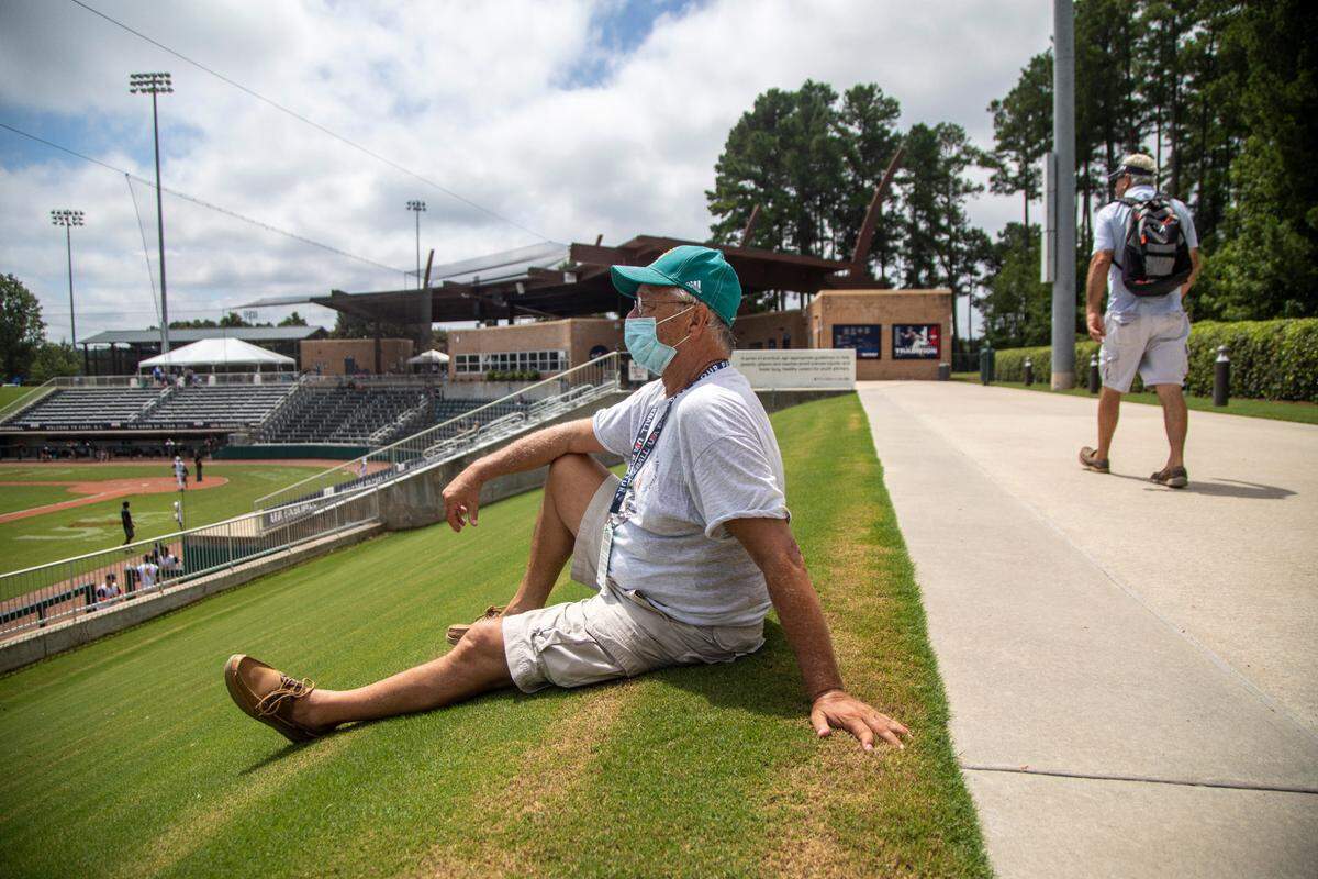 Ken Swarthout, an avid baseball fan, wears a face covering while watching the 17U National Team Championships at the USA Baseball National Training Complex in Cary Thursday, July 30, 2020.