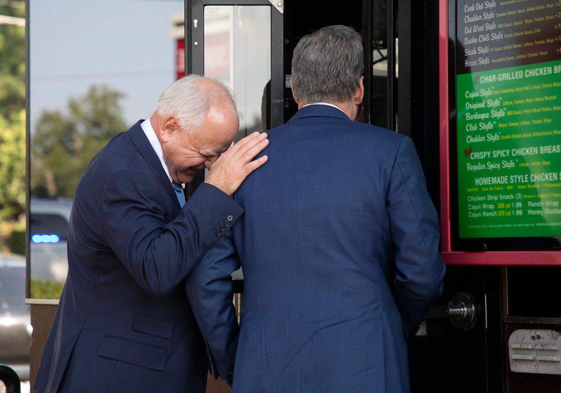 Democratic Vice Presidential nominee and Minnesota Gov. Tim Walz laughs while ordering a Cook Out milkshake with Gov. Roy Cooper during a visit to Raleigh, N.C. on Thursday, Aug. 29, 2024.