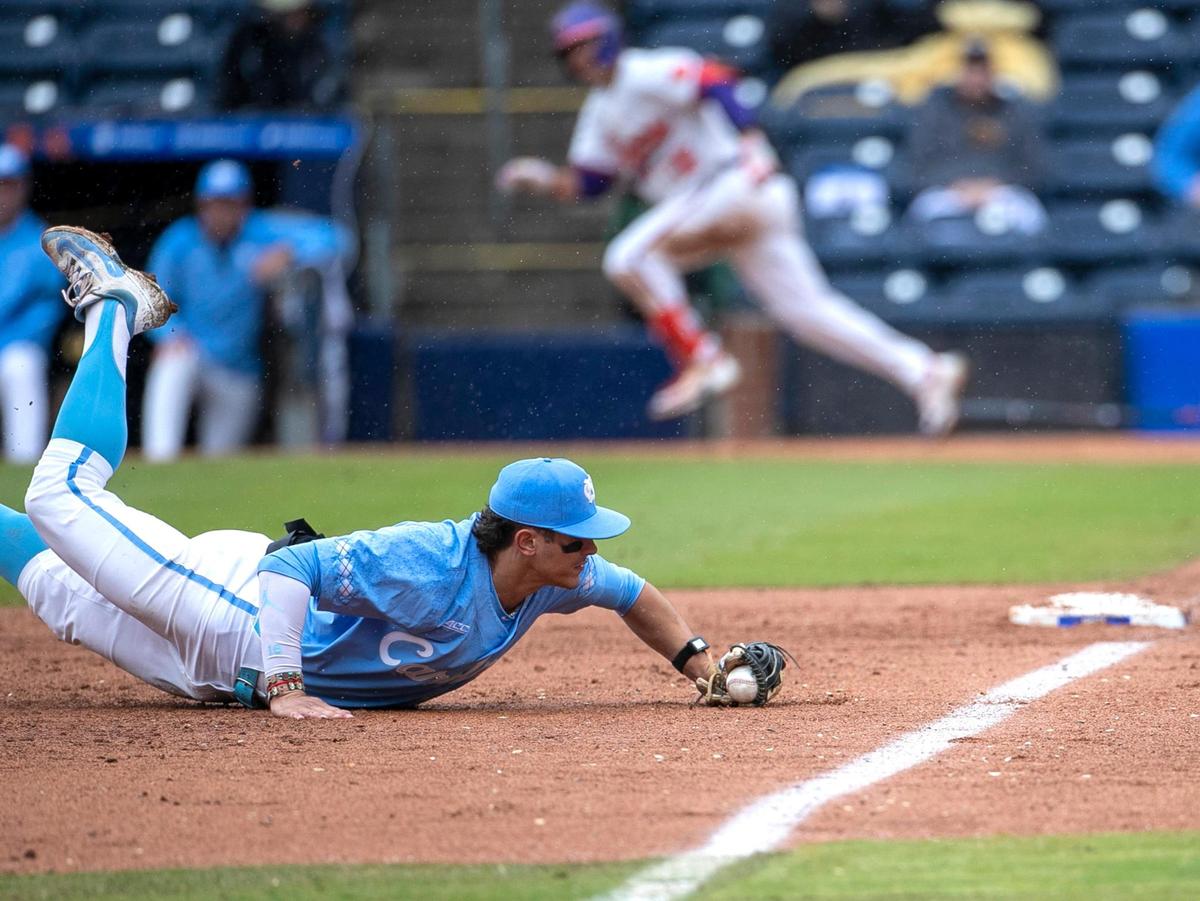 North Carolina third baseman Johnny Castagnozzi (19) fields a base hit by Clemson’s Will Taylor (16) down the third base line in the third inning, during the semi-finals of the 2023 ACC Baseball Championship on Saturday, May 27, 2023 at Durham Bulls Athletic Park in Durham, N.C.