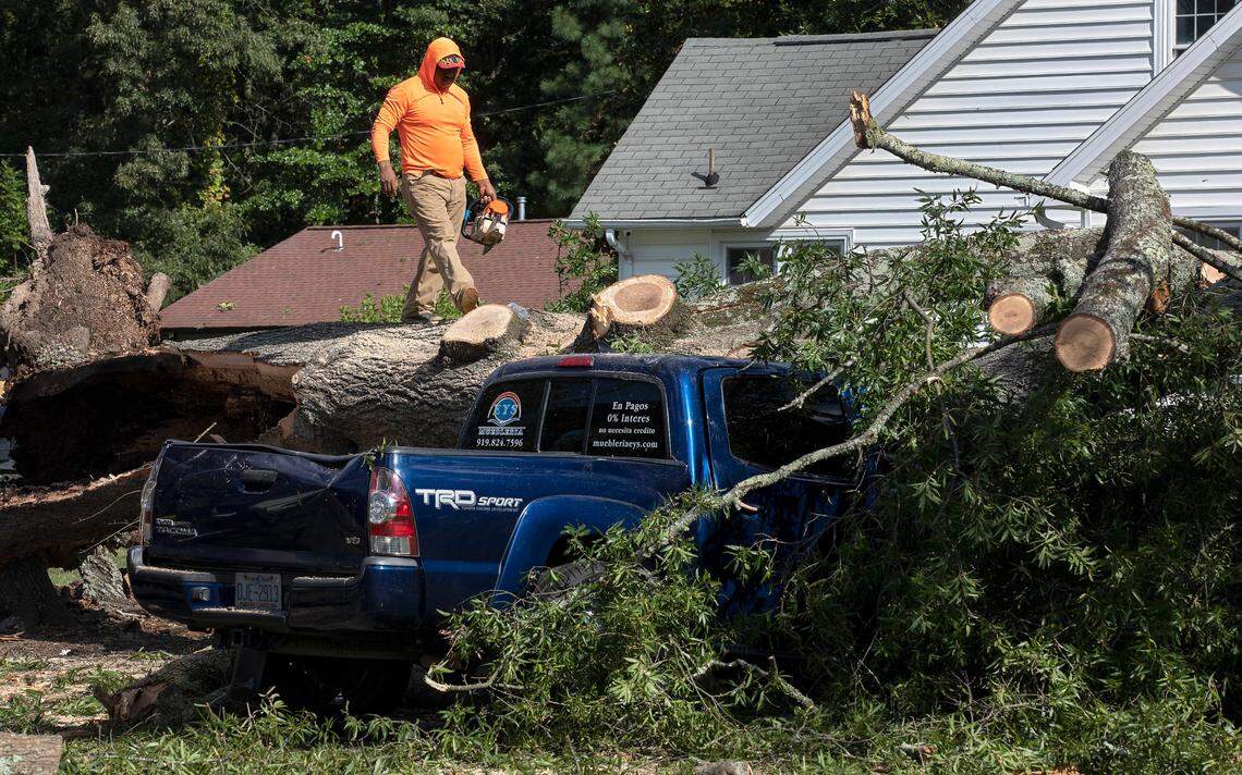 Crews work to remove a downed tree near Guess Road Wednesday, August 16, 2023, following Tuesday evening’s strong storms in Durham, N.C.