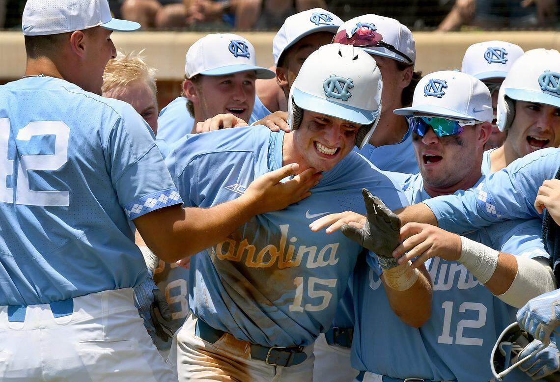 UNC's Michael Busch (15) is greeted by teammates after hitting a two-run homer in the seventh inning during the Super Regional game in Chapel Hill, N.C., Friday, June 8, 2018, against Stetson.