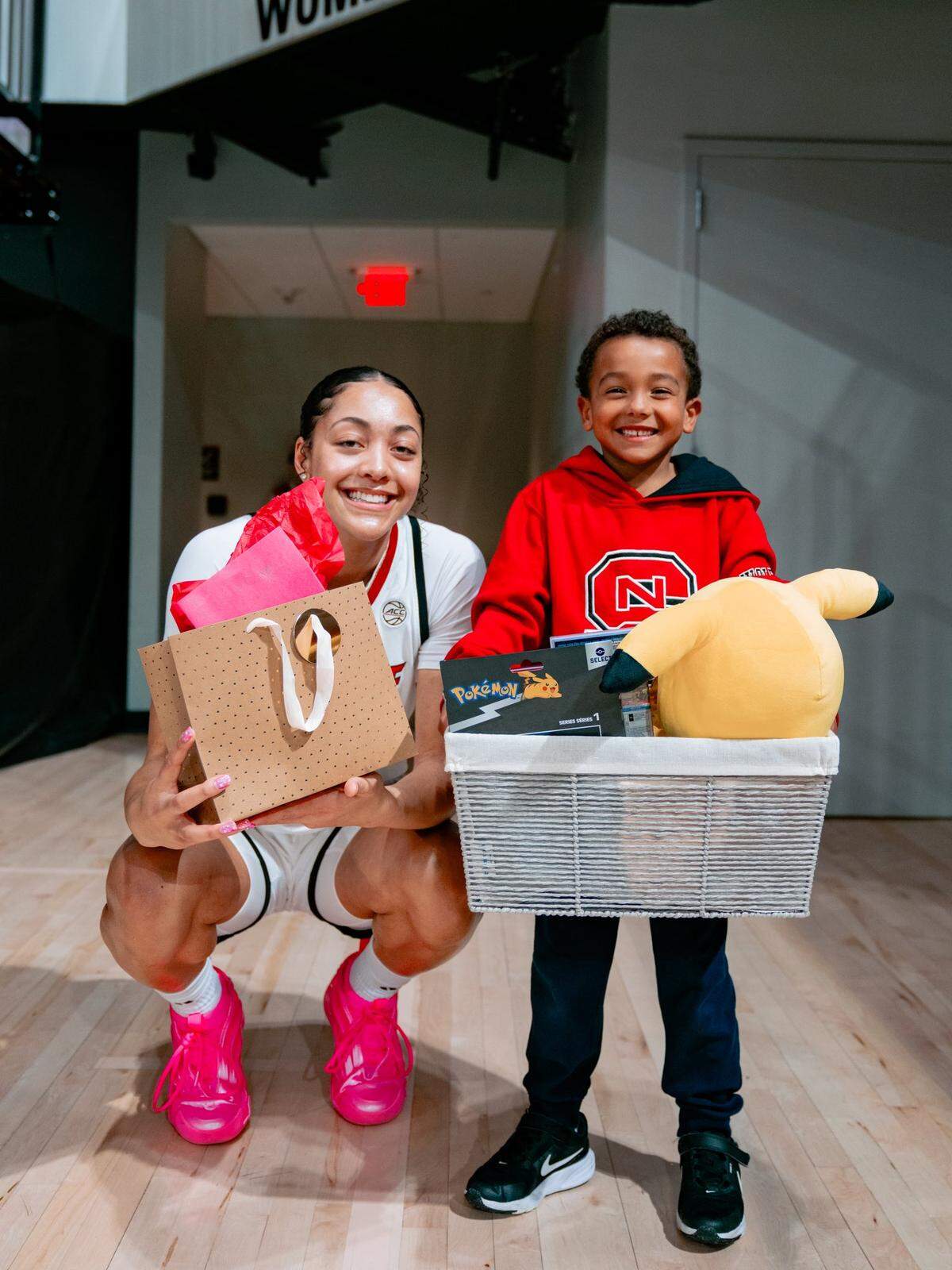 N.C. State forward Khamil Pierre exchanges gifts with fan Braylon Collins after a game at Reynolds Coliseum.