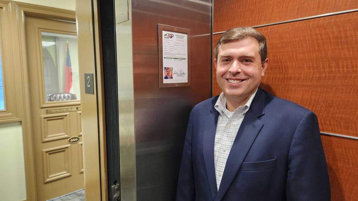 N.C. Labor Commissioner Luke Farley, pictured in the Labor Building in downtown Raleigh on Thursday, Feb. 13, 2025. Farley’s photo, like his predecessors, appears on the elevator inspection certificate in elevators, the first of which with his photo went up in the elevator in his agency’s building.