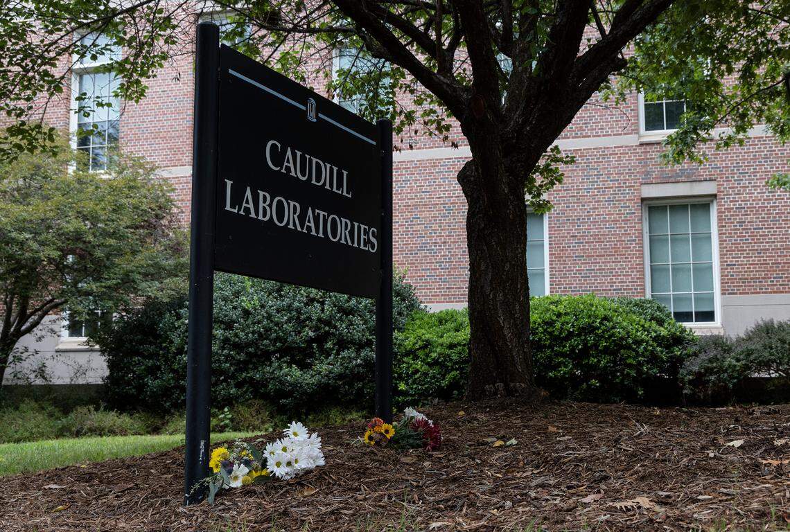 Flowers are left at the base of a sign outside Caudill Laboratories on Tuesday, Aug. 29, 2023, in Chapel Hill, N.C., following a Monday shooting at the lab that left a member of the faculty dead.