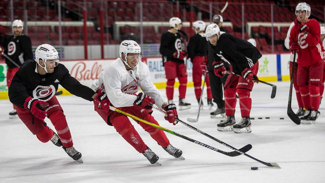 Carolina Hurricanes’ Jesperi Kotkaniemi (82) works against Brett Pesce (22) during the opening day of camp on Thursday, September 23, 2021 at PNC Arena in Raleigh, N.C.