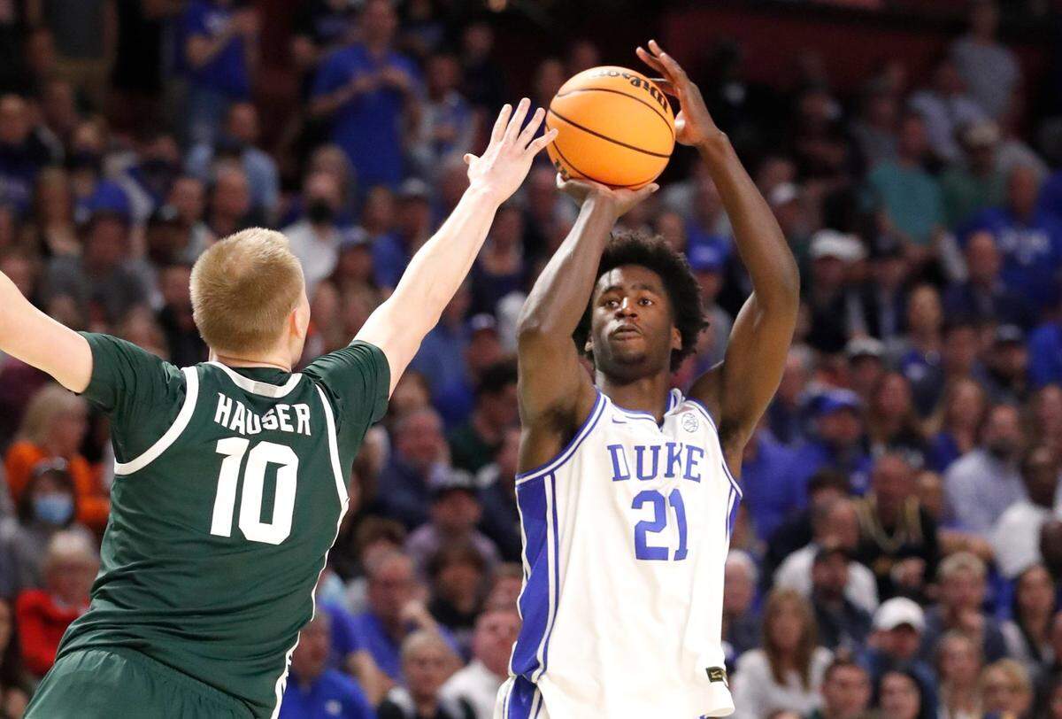 Dukes AJ Griffin (21) shoots as Michigan State’s Joey Hauser (10) defends during the first half of Dukes game against Michigan State in the second round of the NCAA Tournament at Bon Secours Wellness Arena in Greenville, S.C., Sunday, March 20, 2022.