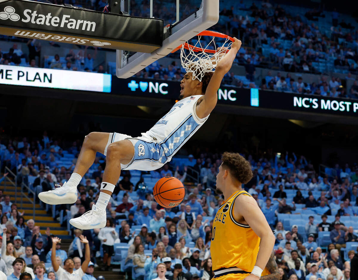 North Carolina’s Seth Trimble hangs on the rim after dunking the ball during the second half of the Tar Heels’ 93-67 win over La Salle on Saturday, Dec. 14, 2024, at the Smith Center in Chapel Hill, N.C.