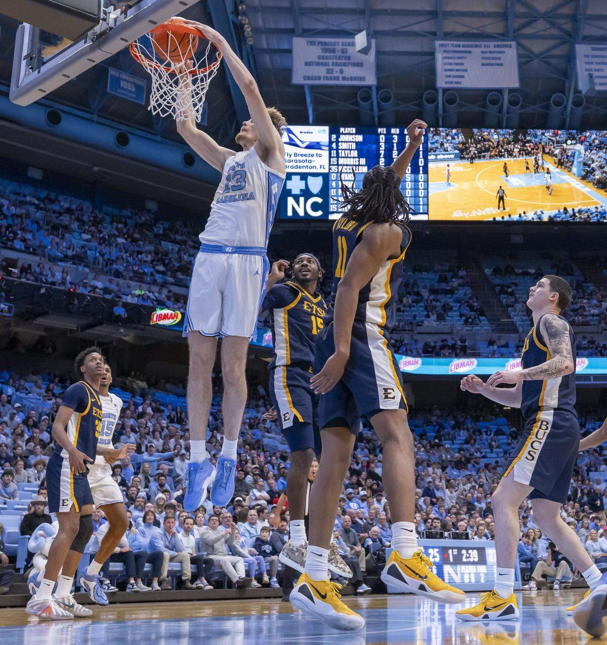 North Carolina center Henri Veesaar (13) breaks to the basket for a dunk ahead of East Tennessee State forward Cam Morris III (15) in the first half on Tuesday, December 16, 2025 at the Smith Center in Chapel Hill, N.C. Veesaar lead all scores with 26 points in the Tar Heels’ 77-58 victory.