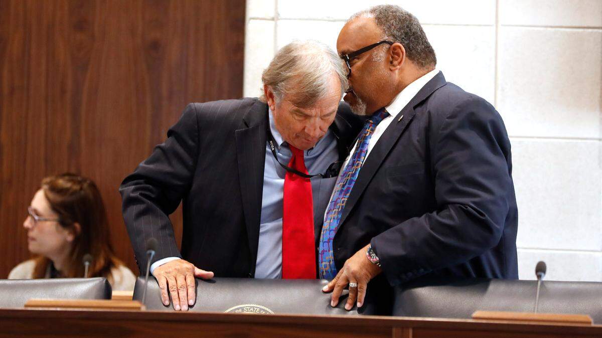 Sen. Paul Lowe, Jr., right, talks with Sen. Bill Rabon before a Senate Judiciary hearing about Senate Bill 711, the N.C. Compassionate Care Act, at the Legislative Building in Raleigh, N.C., Wednesday, June 30, 2021.