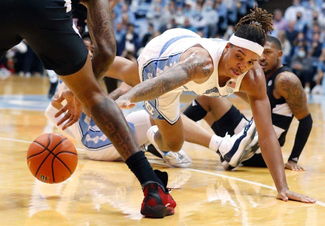 North Carolina’s Armando Bacot (5) dives for a loose ball during the second half of UNCs 70-63 victory over Louisville at the Smith Center in Chapel Hill, N.C., Monday, Feb. 21, 2022.