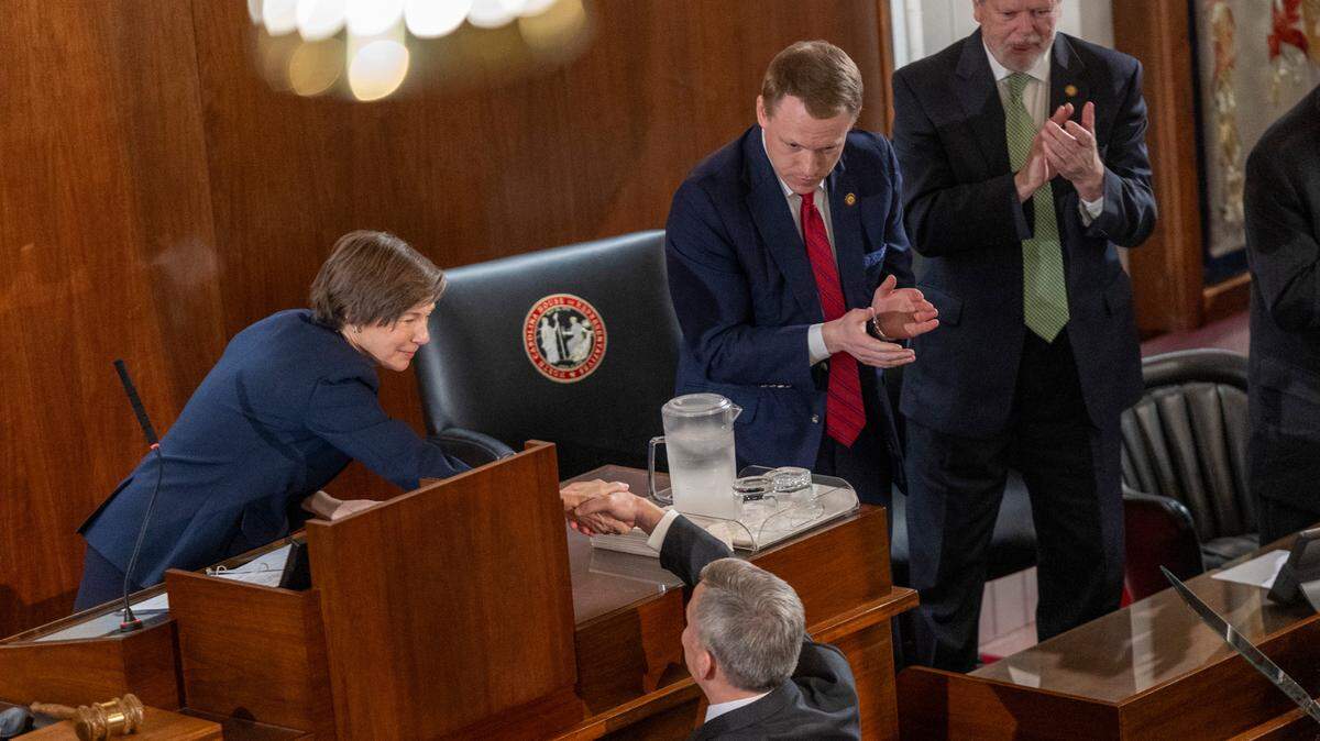Gov. Josh Stein shakes hands with Lt. Gov. Rachel Hunt, House Speaker Destin Hall, and Senate leader Phil Berger after delivering his State of the State address to a joint session of the General Assembly on Wednesday, March 12, 2025, in the House chamber of the Legislative Building.