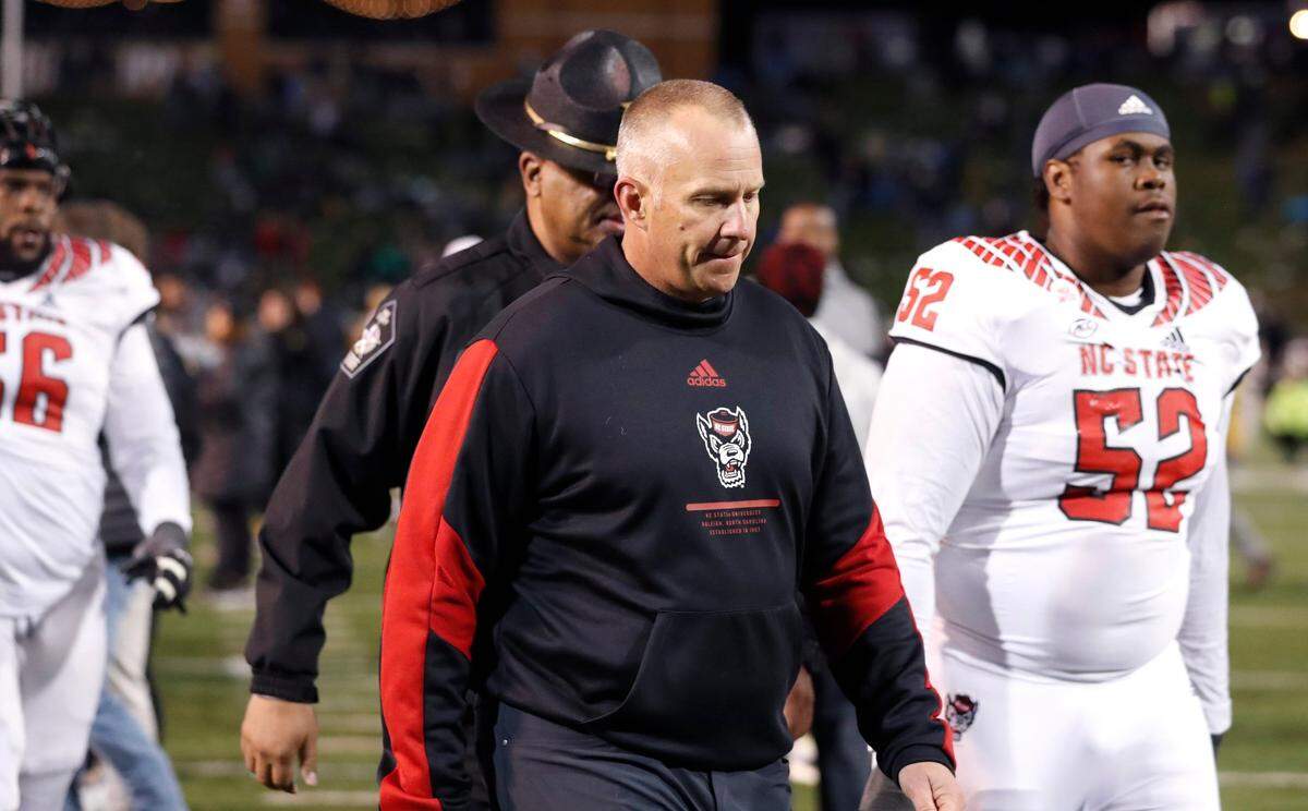 N.C. State head coach Dave Doeren walks off the field after Wake Forest’s 45-42 victory over N.C. State at Truist Field in Winston-Salem, N.C., Saturday, November 13, 2021.