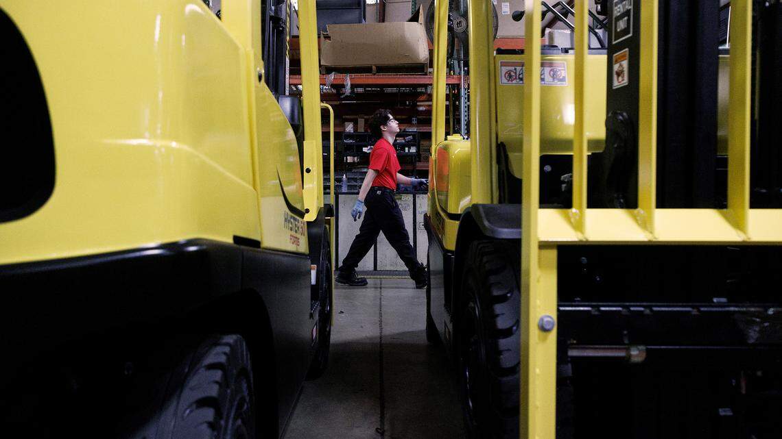 Wake Technical Community College student Dominic Cavallini walks by machinery while working in the shop at The Gregory Poole Equipment Company in Raleigh, N.C. on Thursday, July 18, 2024.