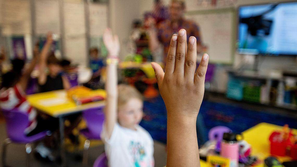 Third graders raise their hands to answer questions during a lesson on fractions at Buckhorn Ridge Elementary in Holly Springs, N.C., in this 2021 file photo.