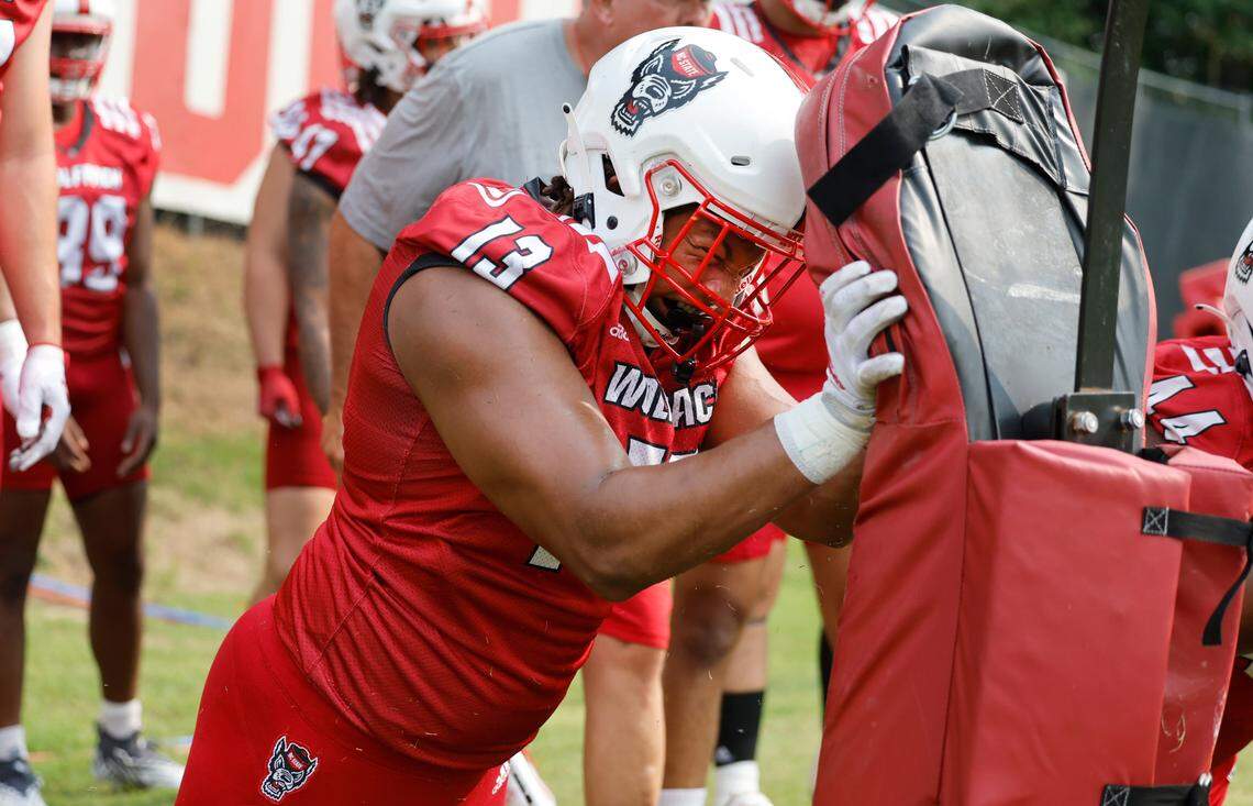 N.C. State defensive end Travali Price (13) attacks the pads during the Wolfpack’s first fall practice in Raleigh, N.C., Wednesday, August 2, 2023.