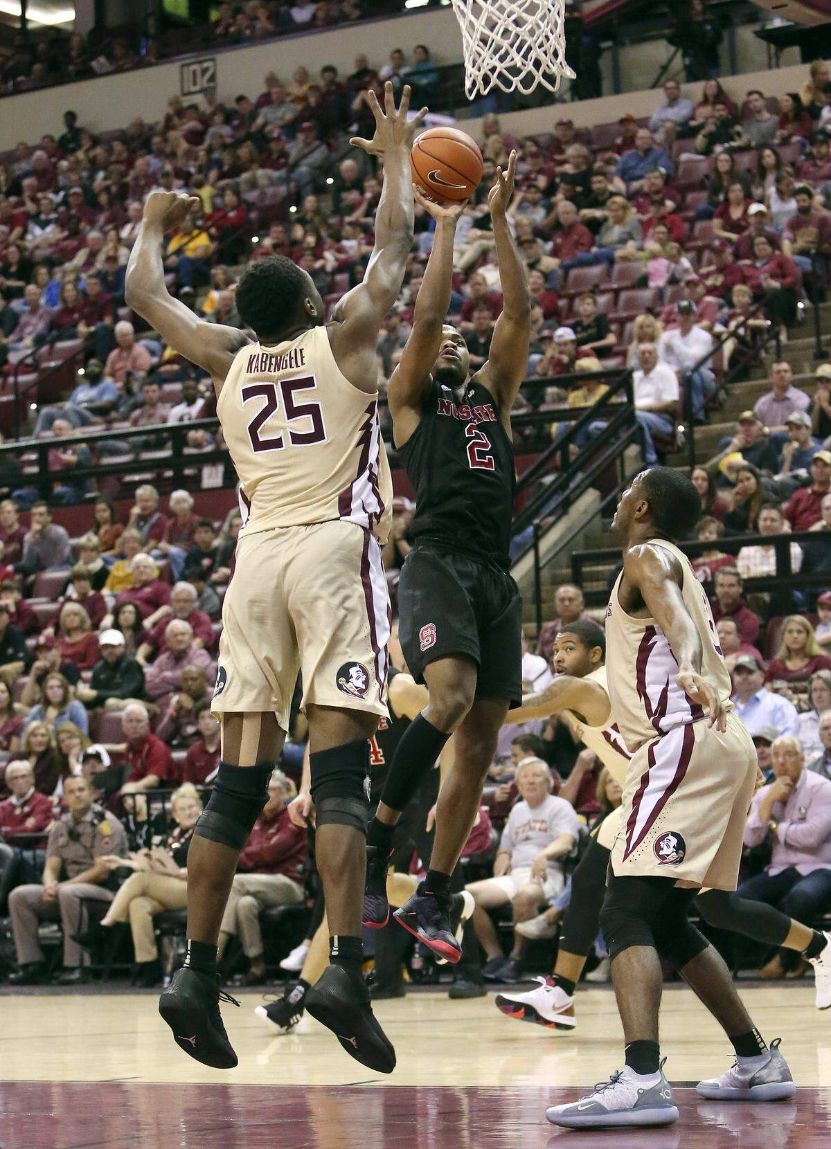 North Carolina State’s Torin Dorn, center shoots over Florida State’s Mfiondu Kabengele in the second half of an NCAA college basketball game Saturday, March 2, 2019, in Tallahassee, Fla. Florida State won 78-73. (AP Photo/Steve Cannon)