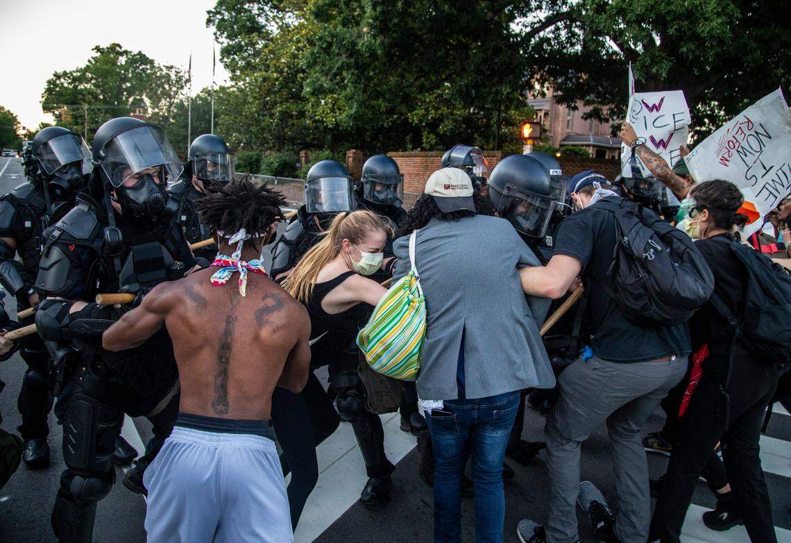 Protesters clash with police in riot gear outside the Executive Mansion during the second day of protests in Raleigh Sunday night May 31, 2020.
