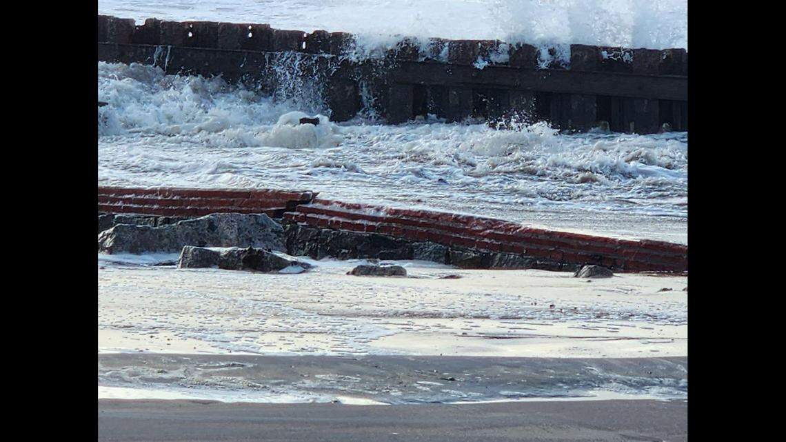 A portion of fence that surrounded the Cape Hatteras Lighthouse has been revealed by Hurricane Lee storm erosion. The fence was built in 1871, and left behind when the lighthouse was moved in 1999, the National Park Service says.