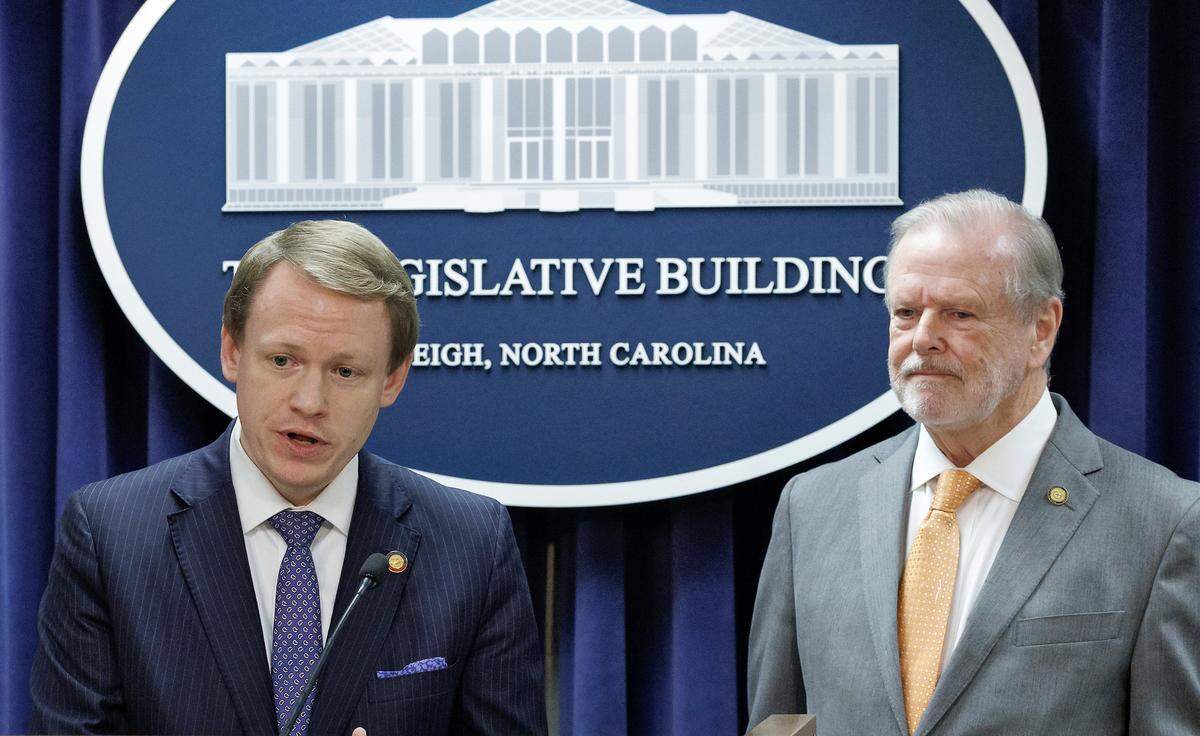 House Speaker Destin Hall speaks while standing with Senate leader Phil Berger during a press conference to announce a state budget deal at the Legislative Building on Tuesday, May 12, 2026, in Raleigh, N.C.