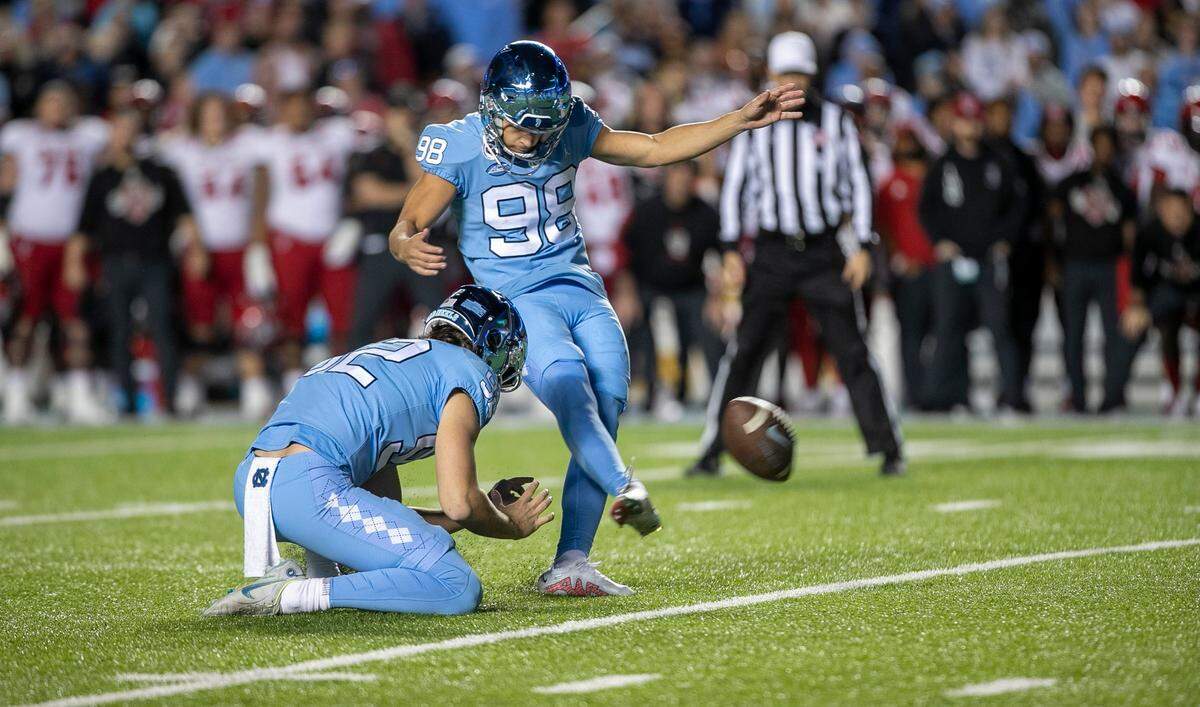 North Carolina kicker Noah Burnette (98) misses a 35-yard field goal attempt in overtime to give N.C. State a 30-27 victory on Friday, November 25, 2022 at Kenan Stadium in Chapel Hill, N.C.