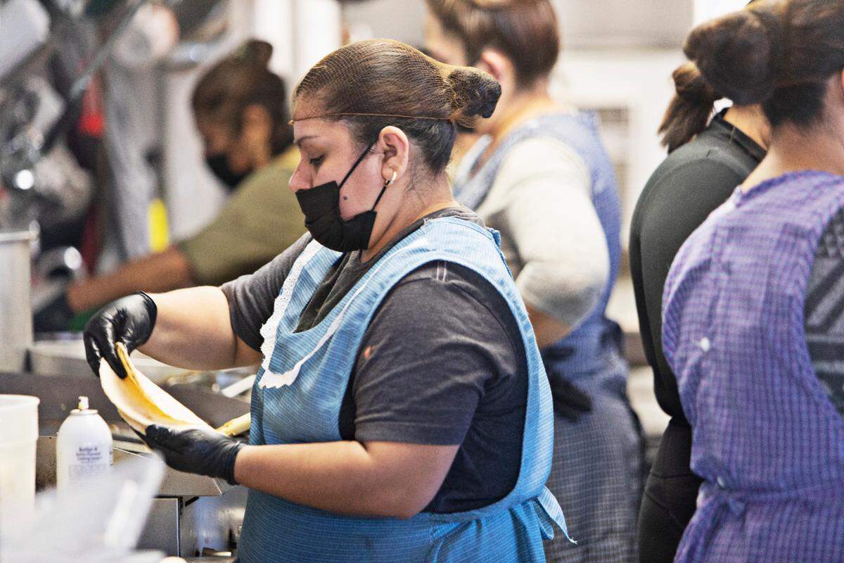 Kitchen staff fill the small kitchen at Fonda Lupita to prep food for the day on Wednesday morning, Jan. 19, 2022. The Sanford restaurant, which serves homestyle Mexican food, including homemade fresh corn tortillas.