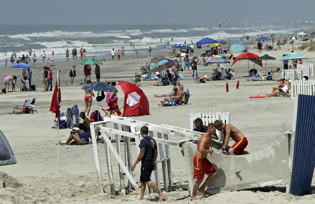 Bathers crowd the beach on Atlantic Beach following Hurricane Arthur on July 4, 2014. Three local businesses are suing the Cartetet County school system for adopting a calendar for the 2024-25 school year that doesn’t follow North Carolina’s school calendar law.