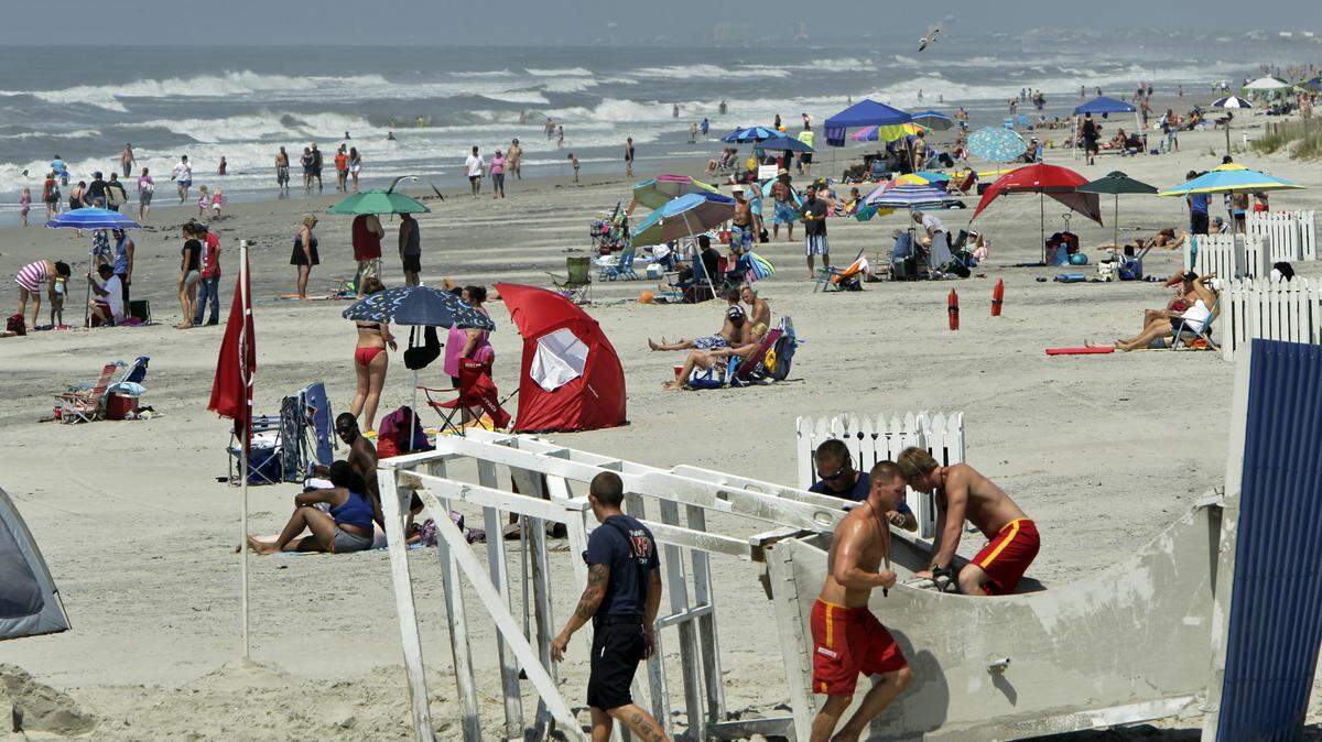 Bathers crowd the beach on Atlantic Beach following Hurricane Arthur on July 4, 2014. The tourism industry is supporting legislation that would allow North Carolina schools to start a week earlier in August in exchange for creating penalties for violating the school calendar law.