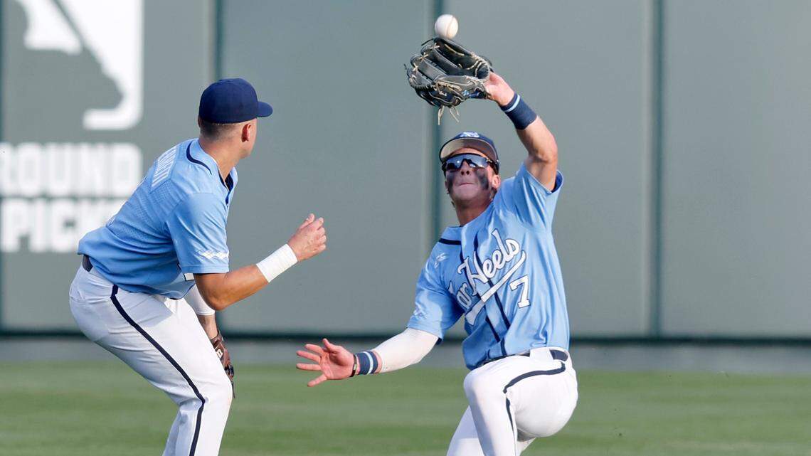 North Carolina’s Vance Honeycutt (7) pulls in the fly ball during UNC’s game against N.C. State at Doak Field in Raleigh, N.C., Friday, May 6, 2022. North Carolina’s Danny Serretti (1) is to the left.