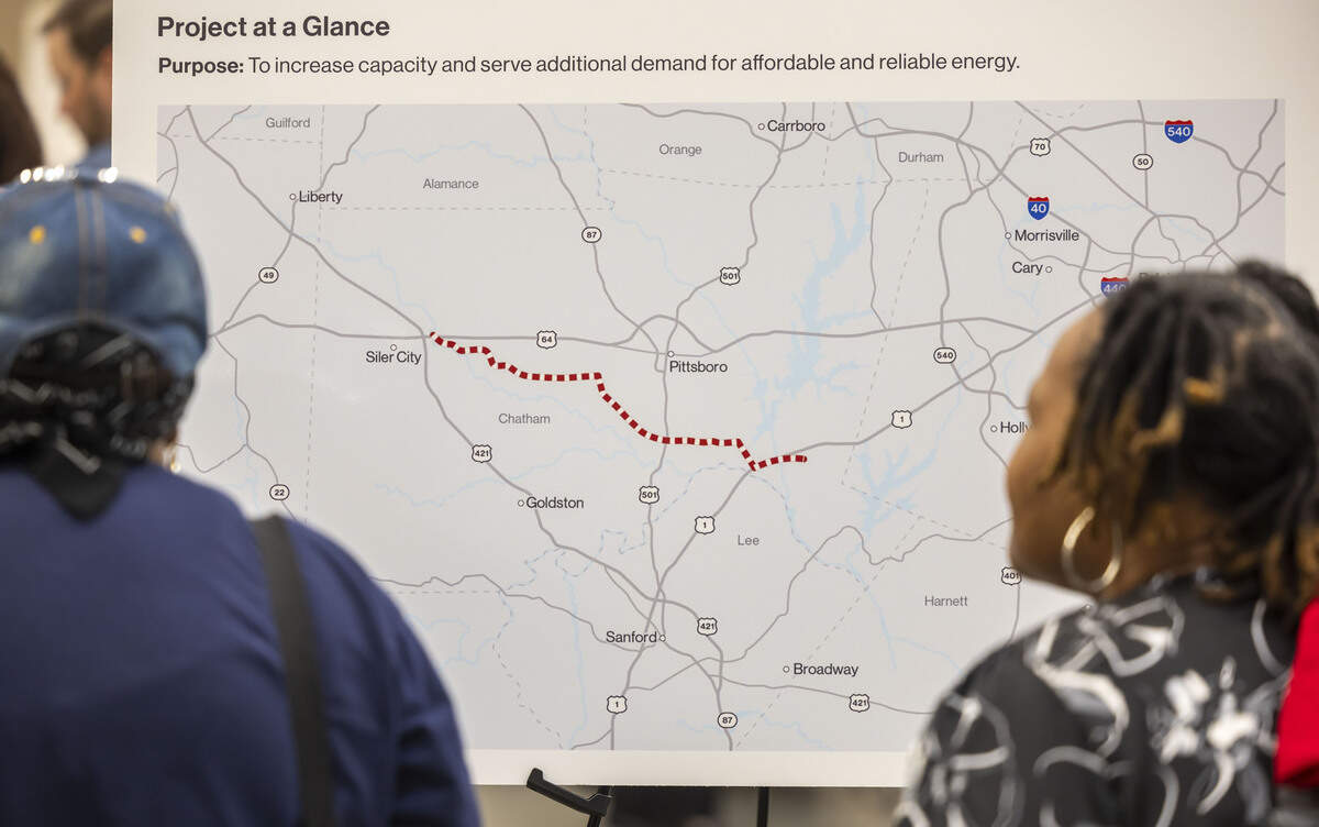 Karen Marsh and Shebra Hackney and of Moncure, N.C. examine the map of a proposed 28-mile natural gas pipeline, on Tuesday, July 28, 2026 Chatham County Agriculture & Conference Center in Pittsboro, N.C.