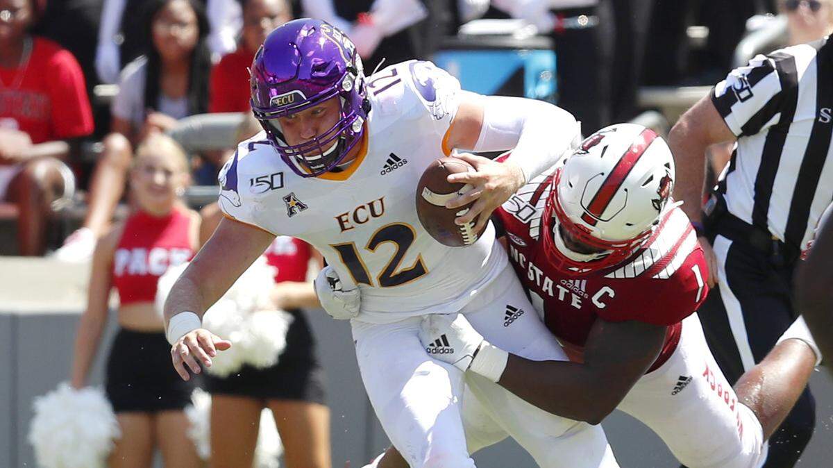 N.C. State defensive end James Smith-Williams (1) sacks East Carolina quarterback Holton Ahlers (12) during the first half of N.C. State’s game against East Carolina University at Carter-Finley Stadium in Raleigh, N.C., Saturday, August 31, 2019.