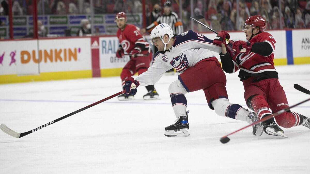 Carolina Hurricanes Martin Necas (88) works to slow Columbus Max Domi (16) during the first period against Columbus on Saturday, March 20, 2021 at PNC Arena in Raleigh, N.C.