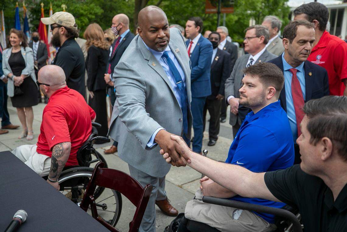 North Carolina Lt. Gov. Mark Robinson shakes hands with veteran Jeff Cambre after Governor Roy Cooper signed House Bill 138/Senate Bill 132, to declare April 24 North Carolinas Wounded heroes Day during a ceremony on the Bicentennial Plaza on Wednesday, April 21, 2021 in Raleigh, NC.