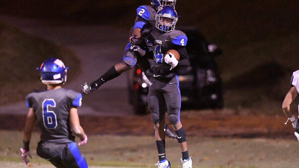Damien Peacock (4) of Wake Forest celebrates along his teammates Hezekiah Foster (2) and Triston Spencer (6) after scoring a touchdown. The Heritage Huskies visited the Wake Forest Cougars in a high school football game on November 8, 2019.