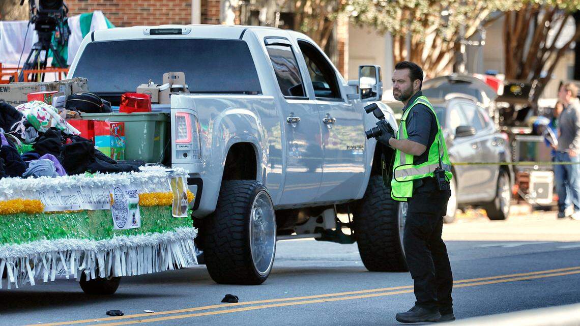 Investigators document the  scene where a truck pulling a float went out of control at the Raleigh Christmas Parade killing a young girl, Saturday, Nov. 19, 2022.