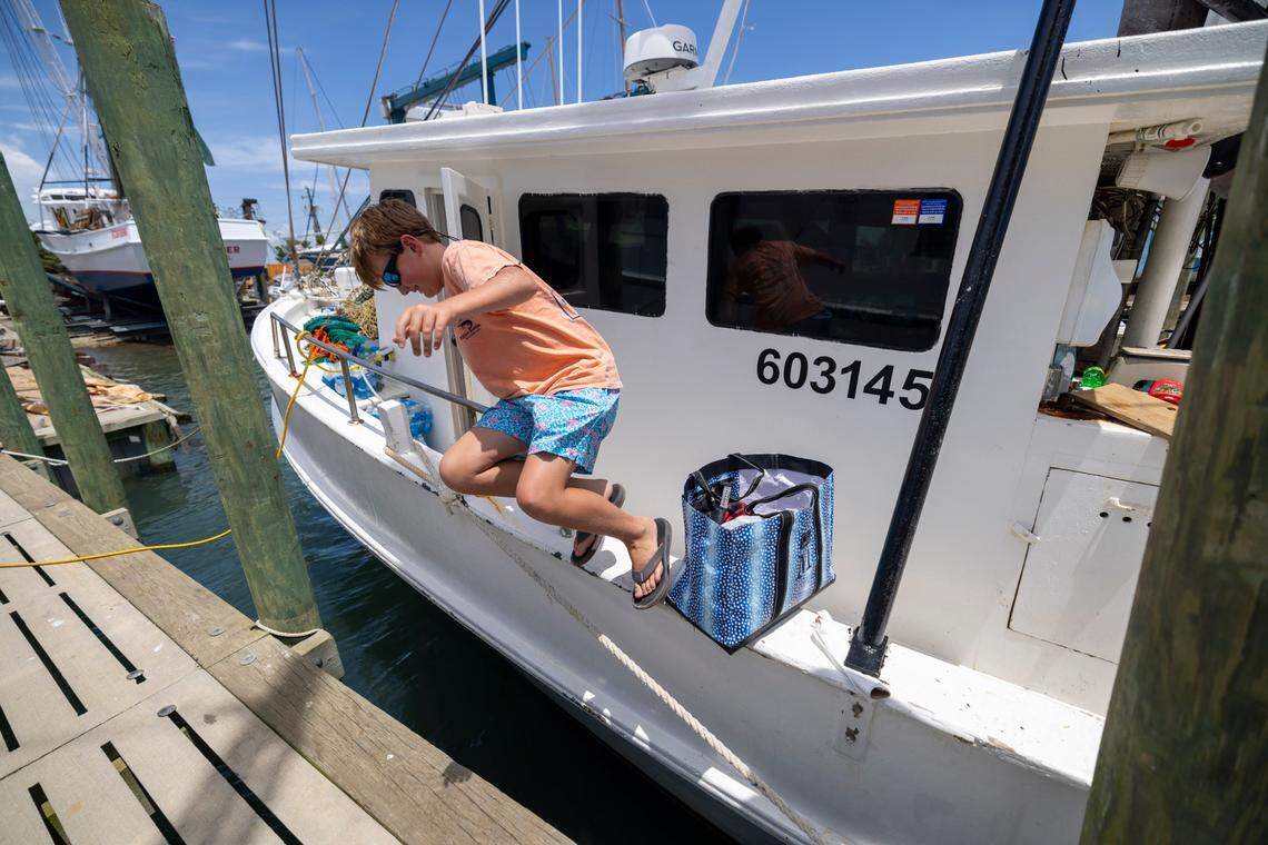 Cameron Smith hops off his father’s boat, the Della John, after returning from a multi-day shrimping trip. Smith said he is looking forward to following in his family’s footsteps and pursuing a career in commercial fishing.