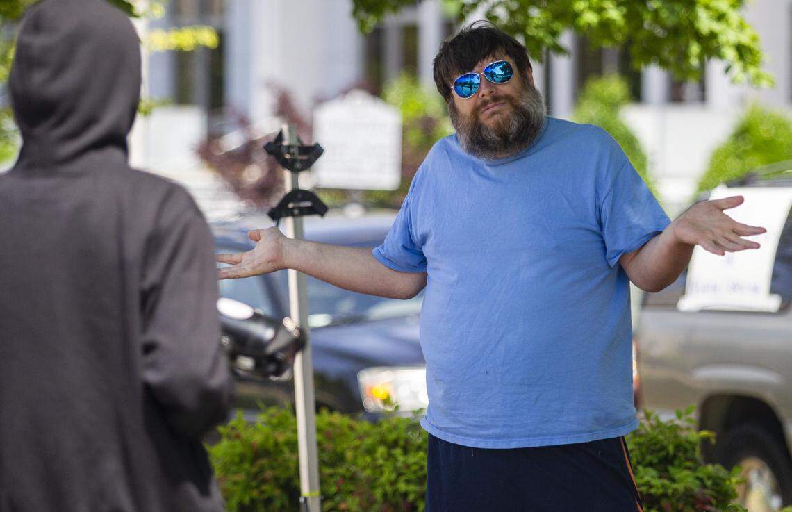 Perry Whitlock is confronted by a counter-protester as a group of about a half dozen mostly armed demonstrators affiliated with the Facebook group Blue Igloo prepare to march in downtown Raleigh Saturday, May, 16, 2020. Whitlock was was shunned by the Blue Igloo group because of his behavior during a demonstration the previous Saturday.